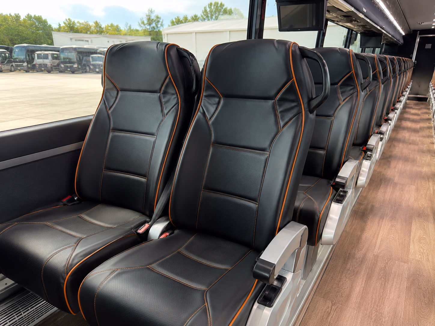 orange construction and film crew shuttle buses